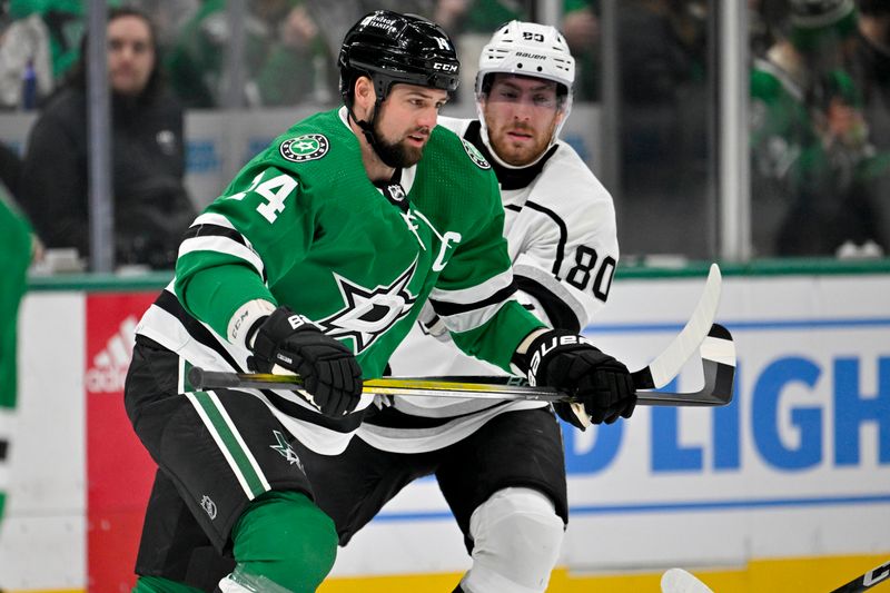 Jan 16, 2024; Dallas, Texas, USA; Dallas Stars left wing Jamie Benn (14) and Los Angeles Kings center Pierre-Luc Dubois (80) look for the puck at center ice during the first period at the American Airlines Center. Mandatory Credit: Jerome Miron-USA TODAY Sports