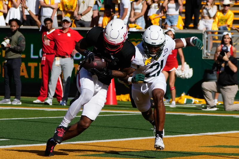 Nov 4, 2023; Waco, Texas, USA;  Houston Cougars wide receiver Samuel Brown (4) catches a touchdown pass against Baylor Bears cornerback Chateau Reed (21) during the first half at McLane Stadium. Mandatory Credit: Chris Jones-USA TODAY Sports