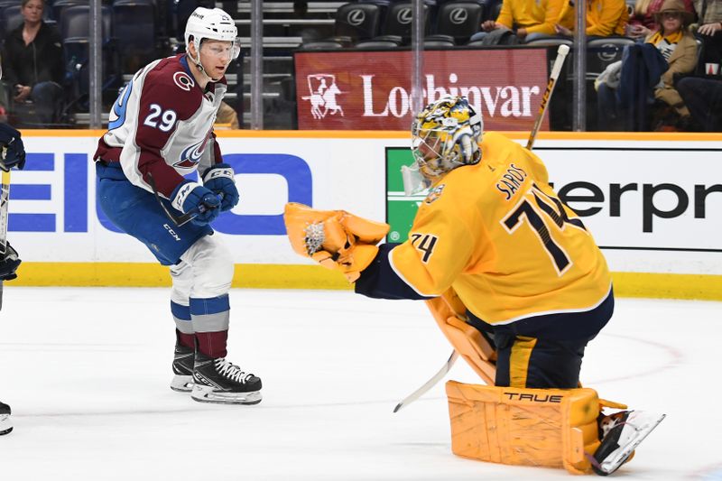 Mar 2, 2024; Nashville, Tennessee, USA; Nashville Predators goaltender Juuse Saros (74) makes a save on a shot by Colorado Avalanche center Nathan MacKinnon (29) during the second period at Bridgestone Arena. Mandatory Credit: Christopher Hanewinckel-USA TODAY Sports