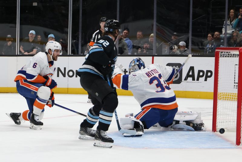 Nov 14, 2025; Salt Lake City, Utah, USA; Utah Mammoth center Logan Cooley (92) waits for a rebound as New York Islanders goaltender David Rittich (33) has a puck make it past him for a goal during the first period at Delta Center. Mandatory Credit: Rob Gray-Imagn Images