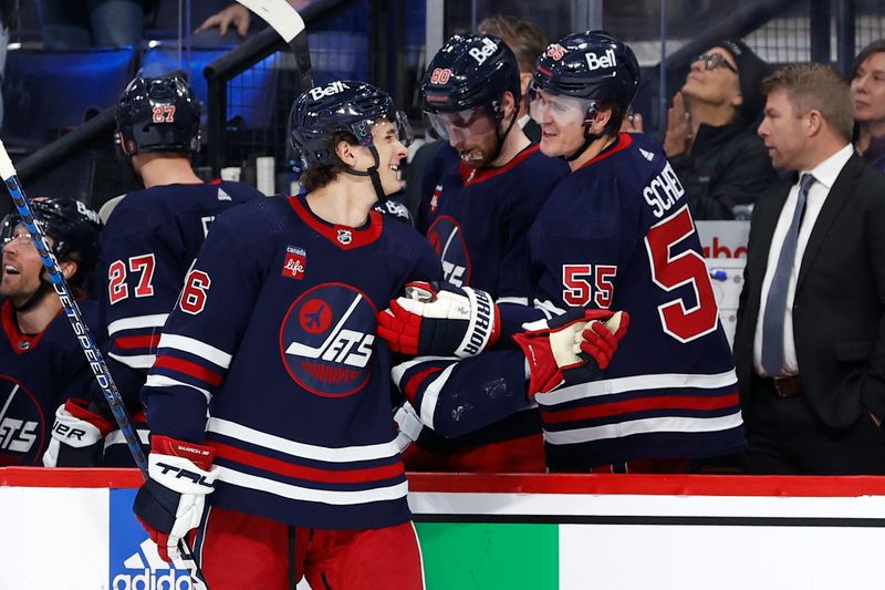 Apr 2, 2023; Winnipeg, Manitoba, CAN; Winnipeg Jets center Mark Scheifele (55) talks to Winnipeg Jets center Morgan Barron (36) after scoring his penalty shot goal in the second period against the New Jersey Devils at Canada Life Centre. Mandatory Credit: James Carey Lauder-USA TODAY Sports