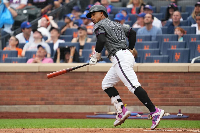 Aug 17, 2024; New York City, New York, USA; New York Mets shortstop Francisco Lindor (12) hits a pop fly for an out during the game against the Miami Marlins at Citi Field. Mandatory Credit: Lucas Boland-USA TODAY Sports