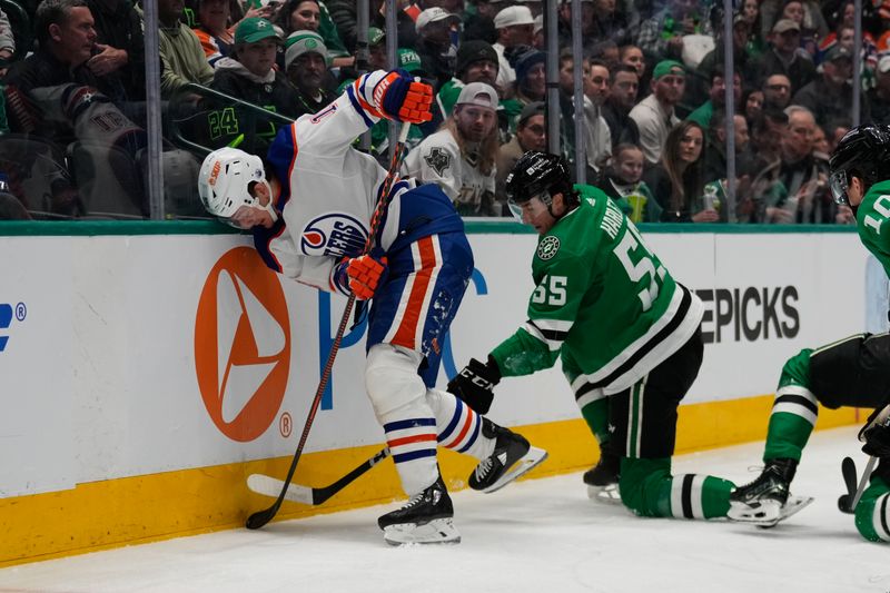 Feb 17, 2024; Dallas, Texas, USA;  Edmonton Oilers center Mattias Janmark (13) is checked by Dallas Stars defenseman Thomas Harley (55) during the first period at American Airlines Center. Mandatory Credit: Chris Jones-USA TODAY Sports