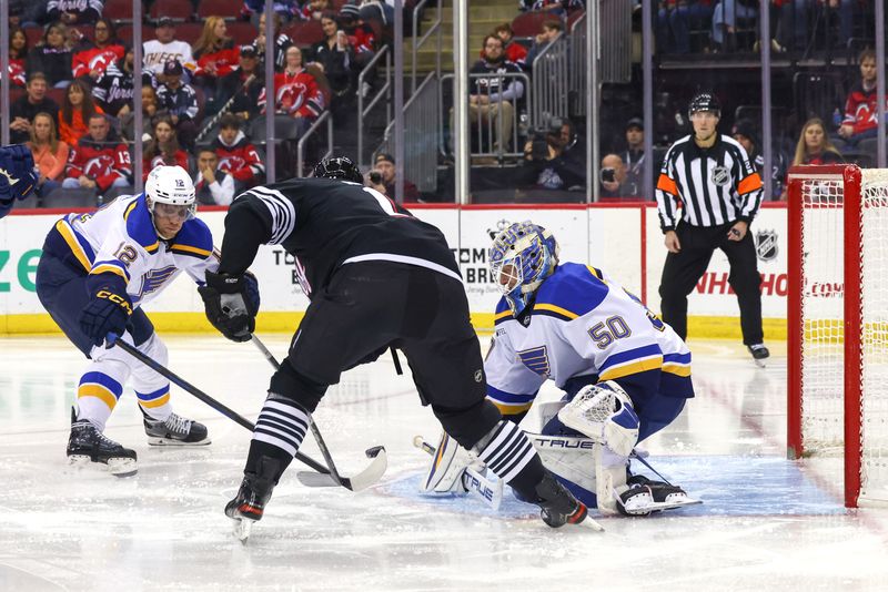 Nov 27, 2024; Newark, New Jersey, USA; St. Louis Blues goaltender Jordan Binnington (50) makes a save against the New Jersey Devils during the second period at Prudential Center. Mandatory Credit: Ed Mulholland-Imagn Images