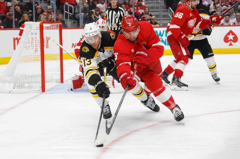 Nov 23, 2024; Detroit, Michigan, USA; Boston Bruins center Charlie Coyle (13) fights for control of the puck with Detroit Red Wings defenseman Justin Holl (3) during the third period at Little Caesars Arena. Mandatory Credit: Brian Bradshaw Sevald-Imagn Images