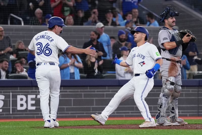 Apr 17, 2024; Toronto, Ontario, CAN; Toronto Blue Jays left fielder Daulton Varsho (25) hits a run home run and celebrates with second baseman Davis Schneider (36) during the second inning against the New York Yankees at Rogers Centre. Mandatory Credit: Nick Turchiaro-USA TODAY Sports