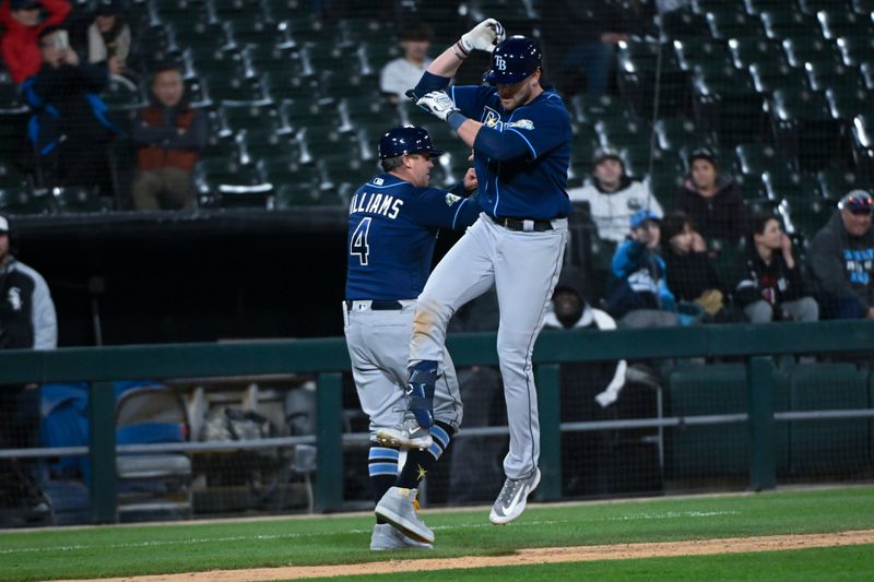 Apr 27, 2023; Chicago, Illinois, USA; Tampa Bay Rays right fielder Luke Raley (55) celebrates with Tampa Bay Rays third base coach Brady Williams (4) after hitting a home run against the Chicago White Sox during the ninth inning at Guaranteed Rate Field. Mandatory Credit: Matt Marton-USA TODAY Sports