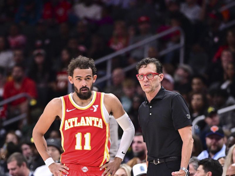 ATLANTA, GA - November 6:  Trae Young #11 and Head Coach Quin Snyder of the Atlanta Hawks look on during the game against the New York Knicks on November 6, 2024 at State Farm Arena in Atlanta, Georgia.  NOTE TO USER: User expressly acknowledges and agrees that, by downloading and/or using this Photograph, user is consenting to the terms and conditions of the Getty Images License Agreement. Mandatory Copyright Notice: Copyright 2024 NBAE (Photo by Adam Hagy/NBAE via Getty Images)