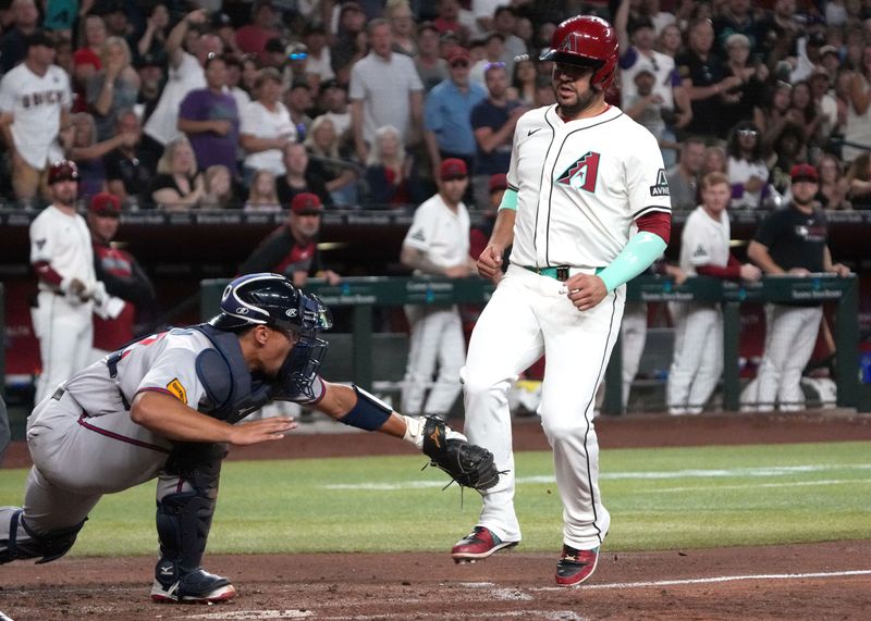 Apr 27, 2025; Phoenix, Arizona, USA; Atlanta Braves catcher Drake Baldwin (30) tags out Arizona Diamondbacks third baseman Eugenio Suarez (28) in the fourth inning at Chase Field. Mandatory Credit: Rick Scuteri-Imagn Images