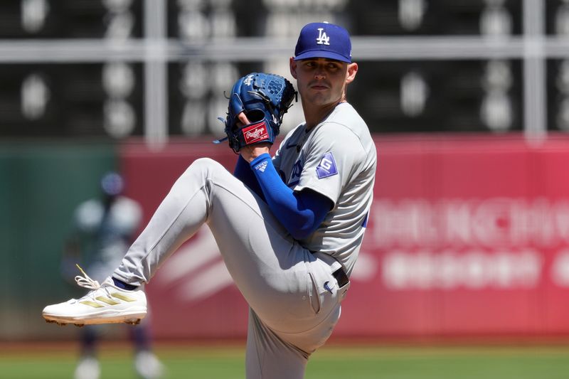 Aug 4, 2024; Oakland, California, USA; Los Angeles Dodgers starting pitcher River Ryan (77) throws a pitch against the Oakland Athletics during the fourth inning at Oakland-Alameda County Coliseum. Mandatory Credit: Darren Yamashita-USA TODAY Sports