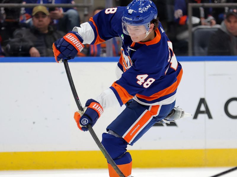 Dec 11, 2025; Elmont, New York, USA; New York Islanders defenseman Matthew Schaefer (48) takes a shot against the Anaheim Ducks during the second period at UBS Arena. Mandatory Credit: Brad Penner-Imagn Images