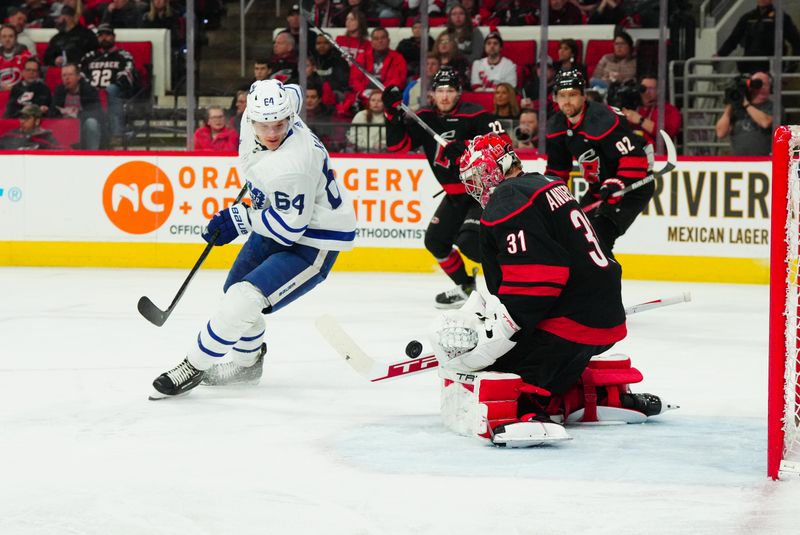 Mar 24, 2024; Raleigh, North Carolina, USA;  Carolina Hurricanes goaltender Frederik Andersen (31) stops the shot in front of Toronto Maple Leafs center David Kampf (64) during the second period at PNC Arena. Mandatory Credit: James Guillory-USA TODAY Sports