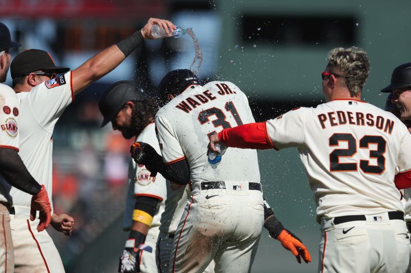 Sep 13, 2023; San Francisco, California, USA; San Francisco Giants first baseman LaMonte Wade Jr. (31) is congratulated by teammates after hitting an rbi sac fly during the tenth inning against the Cleveland Guardians at Oracle Park. Mandatory Credit: Sergio Estrada-USA TODAY Sports
