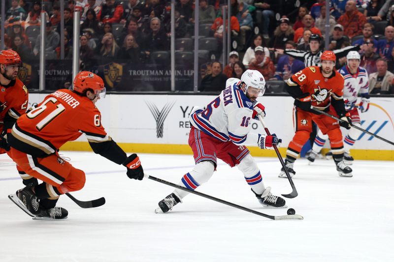 Jan 19, 2026; Anaheim, California, USA;  New York Rangers center Vincent Trocheck (16) fights for the puck against Anaheim Ducks left wing Cutter Gauthier (61) during the first period at Honda Center. Mandatory Credit: Kiyoshi Mio-Imagn Images