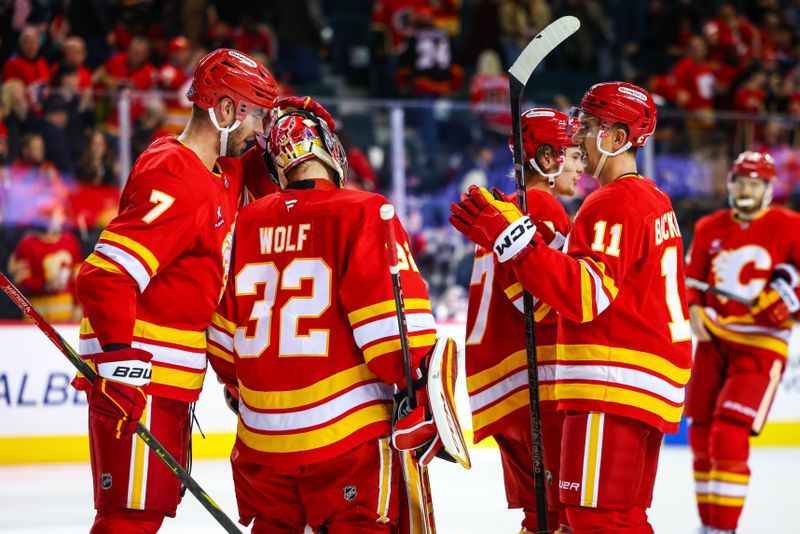 Nov 11, 2024; Calgary, Alberta, CAN; Calgary Flames goaltender Dustin Wolf (32) celebrate win with teammates after defeating Los Angeles Kings at Scotiabank Saddledome. Mandatory Credit: Sergei Belski-Imagn Images