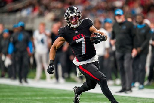 Atlanta Falcons running back Bijan Robinson (7) runs the ball during the first half of an NFL football game against the Carolina Panthers, Sunday, Jan. 5, 2025, in Atlanta. The Panthers defeated the Falcons 44-38. (AP Photo/Danny Karnik)