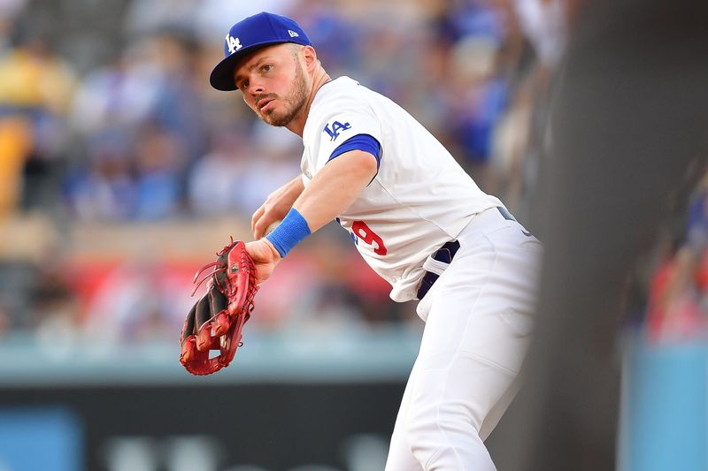 May 4, 2024; Los Angeles, California, USA; Los Angeles Dodgers second baseman Gavin Lux (9) throws to first for the out against Atlanta Braves shortstop Orlando Arcia (11) during the third inning at Dodger Stadium. Mandatory Credit: Gary A. Vasquez-USA TODAY Sports