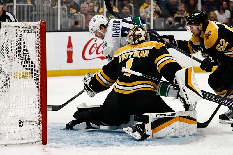 Nov 26, 2024; Boston, Massachusetts, USA; Vancouver Canucks left wing Jake DeBrusk (74) scores on Boston Bruins goaltender Jeremy Swayman (1) during the second period at TD Garden. Mandatory Credit: Winslow Townson-Imagn Images