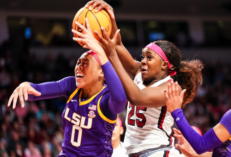 Feb 12, 2023; Columbia, South Carolina, USA; LSU Lady Tigers forward LaDazhia Williams (0) and South Carolina Gamecocks guard Raven Johnson (25) battle for rebound in the first half at Colonial Life Arena. Mandatory Credit: Jeff Blake-USA TODAY Sports