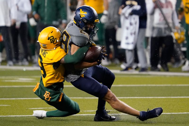 Nov 25, 2023; Waco, Texas, USA; West Virginia Mountaineers wide receiver Preston Fox (29) is tackled by Baylor Bears cornerback Caden Jenkins (19) during the first half at McLane Stadium. Mandatory Credit: Raymond Carlin III-USA TODAY Sports