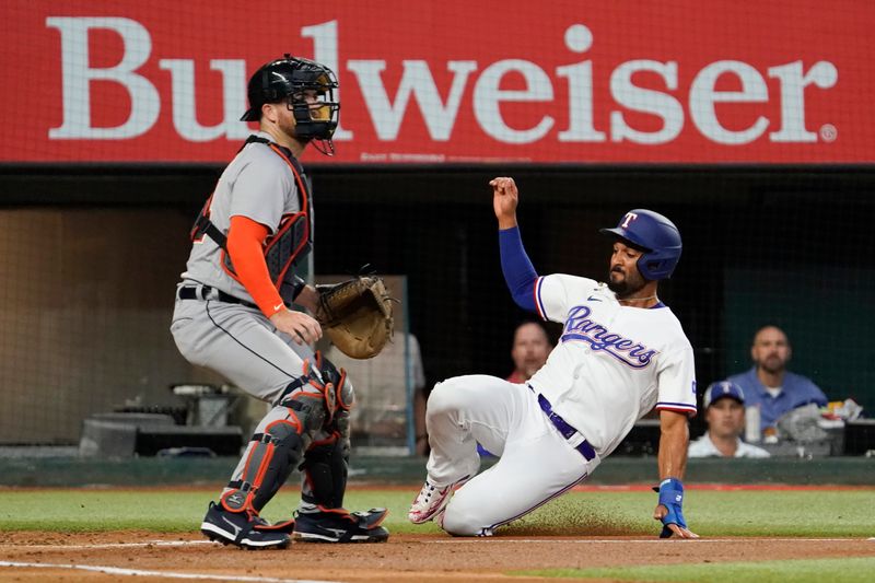 Jun 29, 2023; Arlington, Texas, USA; Texas Rangers second baseman Marcus Semien (2) slides home safely in front of Detroit Tigers catcher Jake Rogers (34) during the first inning at Globe Life Field. Mandatory Credit: Raymond Carlin III-USA TODAY Sports