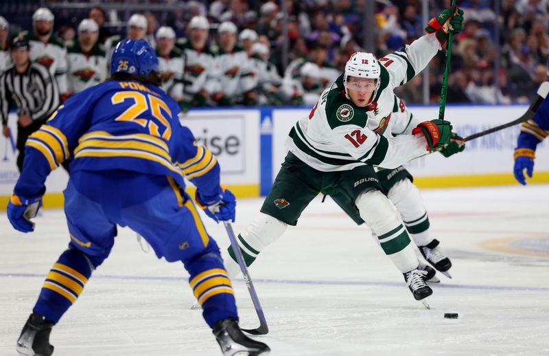 Nov 10, 2023; Buffalo, New York, USA;  Buffalo Sabres defenseman Owen Power (25) looks to block a shot by Minnesota Wild left wing Matt Boldy (12) during the third period at KeyBank Center. Mandatory Credit: Timothy T. Ludwig-USA TODAY Sports