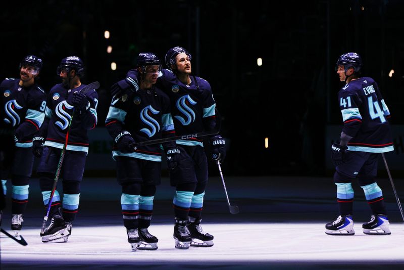 Feb 28, 2026; Seattle, Washington, USA; Seattle Kraken defenseman Brandon Montour (62) celebrates with Seattle Kraken left wing Jaden Schwartz (17) after the game against the Vancouver Canucks at Climate Pledge Arena. Mandatory Credit: Blake Dahlin-Imagn Images