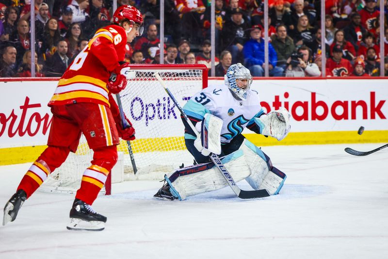 Mar 4, 2024; Calgary, Alberta, CAN; Seattle Kraken goaltender Philipp Grubauer (31) makes a save against the Calgary Flames during the second period at Scotiabank Saddledome. Mandatory Credit: Sergei Belski-USA TODAY Sports