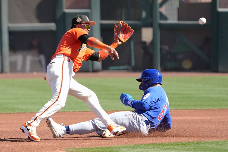 Feb 22, 2026; Scottsdale, Arizona, USA; Chicago Cubs third baseman Matt Shaw (6) slides under the tag by San Francisco Giants shortstop Willy Adames (2) in the first inning at Scottsdale Stadium. Mandatory Credit: Rick Scuteri-Imagn Images