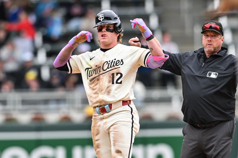 Apr 27, 2025; Minneapolis, Minnesota, USA; Minnesota Twins outfielder Harrison Bader (12) reacts after hitting a double off Los Angeles Angels pitcher Ryan Zeferjahn (not pictured) during the seventh inning at Target Field. Bader would later come around to score. Mandatory Credit: Jeffrey Becker-Imagn Images
