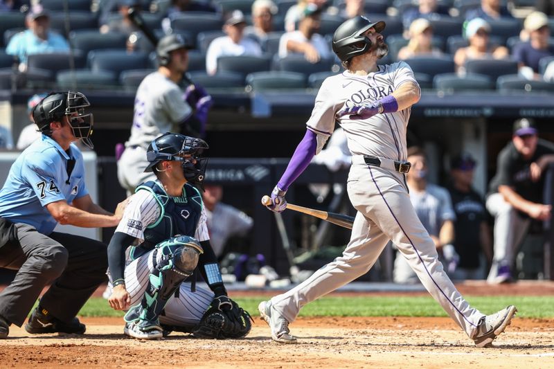 Aug 24, 2024; Bronx, New York, USA;  Colorado Rockies right fielder Jake Cave (11) hits a two run single in the third inning against the New York Yankees at Yankee Stadium. Mandatory Credit: Wendell Cruz-USA TODAY Sports