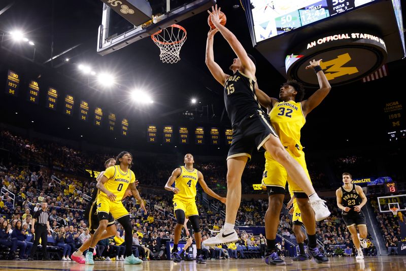 Feb 25, 2024; Ann Arbor, Michigan, USA;  Purdue Boilermakers center Zach Edey (15) shoots on Michigan Wolverines forward Tarris Reed Jr. (32) in the second half at Crisler Center. Mandatory Credit: Rick Osentoski-USA TODAY Sports