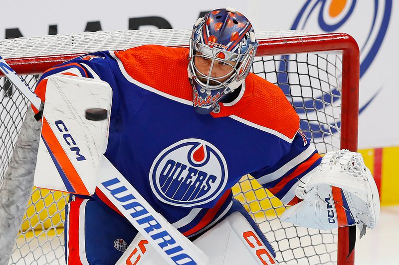 Sep 25, 2022; Edmonton, Alberta, CAN; Edmonton Oilers goaltender Stuart Skinner (74) makes a save during warmup against the Winnipeg Jets at Rogers Place. Mandatory Credit: Perry Nelson-USA TODAY Sports