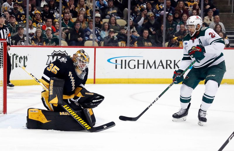 Apr 6, 2023; Pittsburgh, Pennsylvania, USA; Pittsburgh Penguins goaltender Tristan Jarry (35) makes a save in front of Minnesota Wild defenseman Matt Dumba (24) during the first period at PPG Paints Arena. Mandatory Credit: Charles LeClaire-USA TODAY Sports