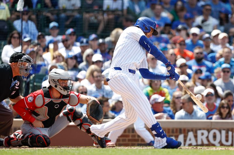 Jun 2, 2024; Chicago, Illinois, USA; Chicago Cubs outfielder Cody Bellinger (24) hits an RBI single against the Cincinnati Reds during the fifth inning at Wrigley Field. Mandatory Credit: Kamil Krzaczynski-USA TODAY Sports