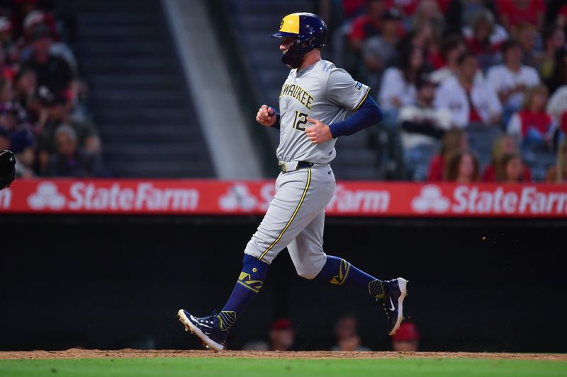 Jun 18, 2024; Anaheim, California, USA; Milwaukee Brewers first base Rhys Hoskins (12) scores a run against the Los Angeles Angels during the sixth inning at Angel Stadium. Mandatory Credit: Gary A. Vasquez-USA TODAY Sports