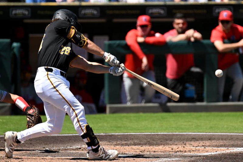 Mar 18, 2025; Bradenton, Florida, USA; Pittsburgh Pirates second baseman Adam Frazier (26) hits an infield single in the second  inning against the Philadelphia Phillies during spring training at LECOM Park. Mandatory Credit: Jonathan Dyer-Imagn Images