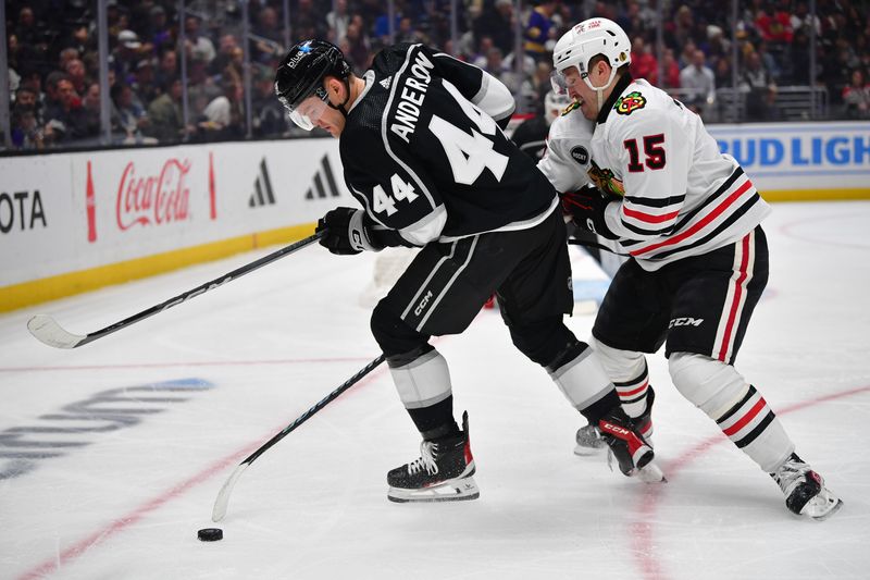 Apr 18, 2024; Los Angeles, California, USA; Chicago Blackhawks right wing Joey Anderson (15) plays for the puck against Los Angeles Kings defenseman Mikey Anderson (44) during the first period at Crypto.com Arena. Mandatory Credit: Gary A. Vasquez-USA TODAY Sports