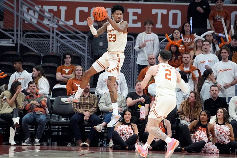 Feb 19, 2024; Austin, Texas, USA; Texas Longhorns forward Dillon Mitchell (23) saves the ball from going out of bounds during the second half against the Kansas State Wildcats at Moody Center. Mandatory Credit: Scott Wachter-USA TODAY Sports