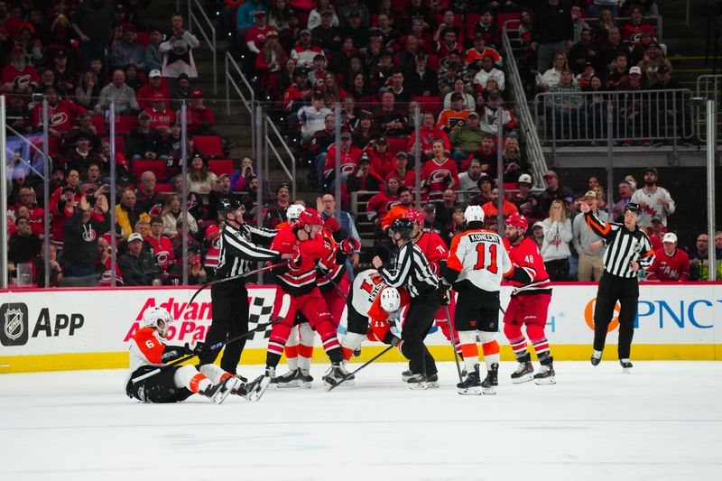 Mar 21, 2024; Raleigh, North Carolina, USA; Carolina Hurricanes right wing Andrei Svechnikov (37) and Philadelphia Flyers right wing Travis Konecny (11) battle during the third period at PNC Arena. Mandatory Credit: James Guillory-USA TODAY Sports