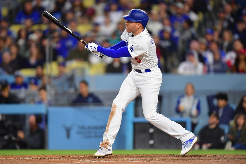 May 4, 2024; Los Angeles, California, USA; Los Angeles Dodgers first baseman Freddie Freeman (5) hits a triple against the Atlanta Braves during the sixth inning at Dodger Stadium. Mandatory Credit: Gary A. Vasquez-USA TODAY Sports