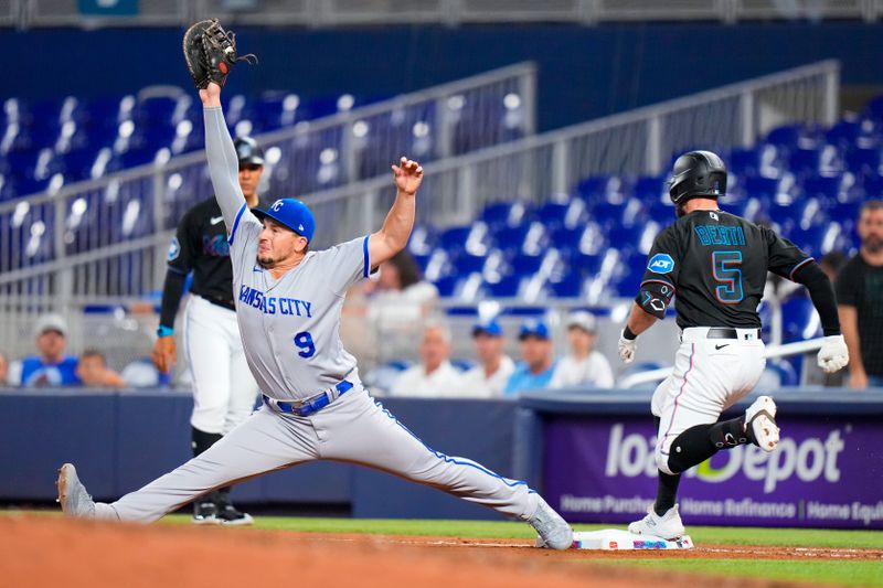 Jun 7, 2023; Miami, Florida, USA; Kansas City Royals first baseman Vinnie Pasquantino (9) tags out Miami Marlins shortstop Jon Berti (5) during the seventh inning at loanDepot Park. Mandatory Credit: Rich Storry-USA TODAY Sports