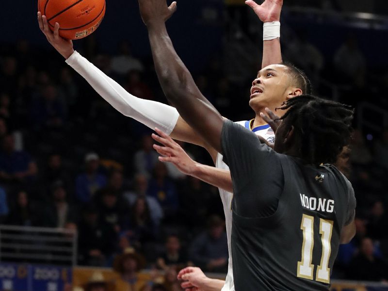 Feb 25, 2025; Pittsburgh, Pennsylvania, USA;  Pittsburgh Panthers guard Jaland Lowe (15) shoots against Georgia Tech Yellow Jackets forward Baye Ndongo (11) during the second half at the Petersen Events Center. Mandatory Credit: Charles LeClaire-Imagn Images