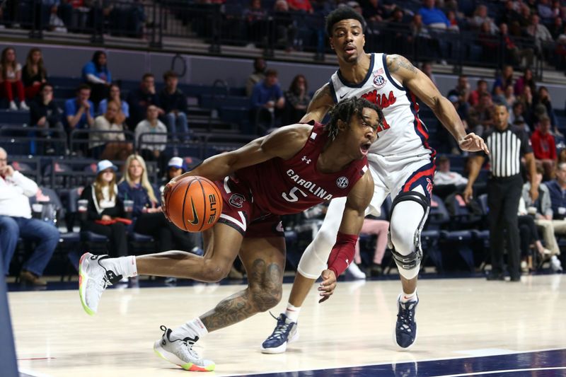 Feb 11, 2023; Oxford, Mississippi, USA; South Carolina Gamecocks guard Meechie Johnson (5) dribbles as Mississippi Rebels forward Robert Allen (21) defends during the first half at The Sandy and John Black Pavilion at Ole Miss. Mandatory Credit: Petre Thomas-USA TODAY Sports