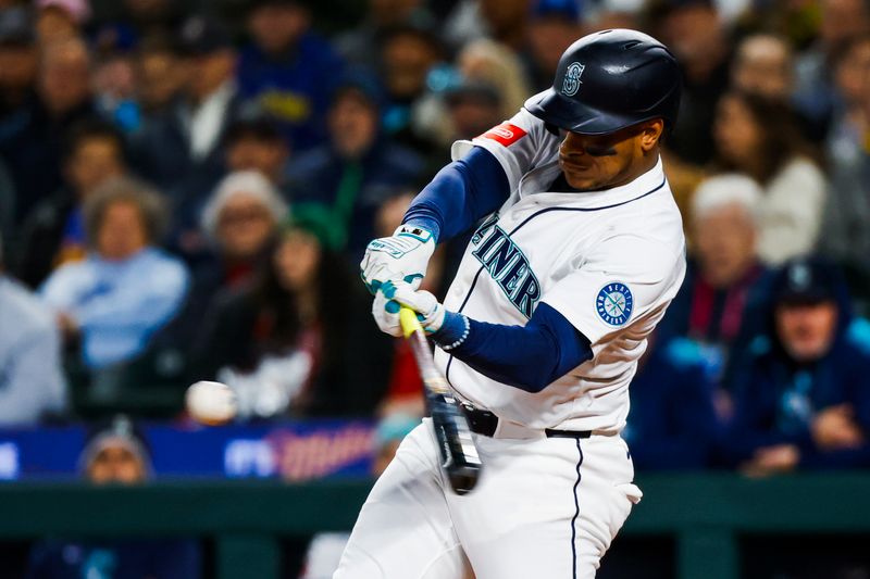 Apr 29, 2025; Seattle, Washington, USA; Seattle Mariners designated hitter Jorge Polanco (7) hits a three-run home run against the Los Angeles Angels during the second inning at T-Mobile Park. Mandatory Credit: Joe Nicholson-Imagn Images