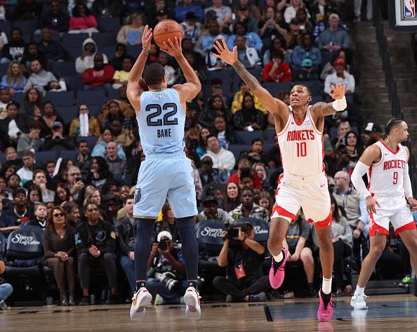 MEMPHIS, TN - DECEMBER 15:  Jabari Smith Jr. #10 of the Houston Rockets plays defense against Desmond Bane #22 of the Memphis Grizzlies during the game on December 15, 2023 at FedExForum in Memphis, Tennessee. NOTE TO USER: User expressly acknowledges and agrees that, by downloading and or using this photograph, User is consenting to the terms and conditions of the Getty Images License Agreement. Mandatory Copyright Notice: Copyright 2023 NBAE (Photo by Joe Murphy/NBAE via Getty Images)