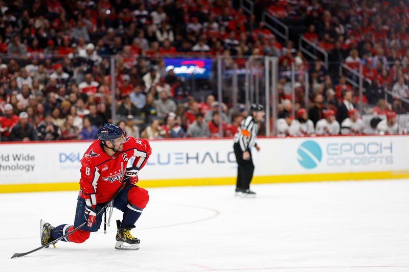 Jan 5, 2024; Washington, District of Columbia, USA; Washington Capitals left wing Alex Ovechkin (8) gets back on his feet after being injured against the Carolina Hurricanes in the third period at Capital One Arena. Mandatory Credit: Geoff Burke-USA TODAY Sports