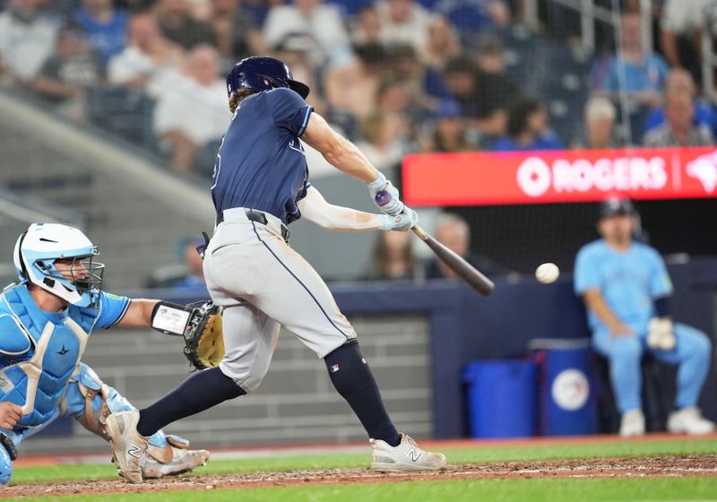 Jul 23, 2024; Toronto, Ontario, CAN; Tampa Bay Rays shortstop Taylor Walls (6) gets on first base on a fielder’s choice against the Toronto Blue Jays during the ninth inning at Rogers Centre. Mandatory Credit: Nick Turchiaro-USA TODAY Sports