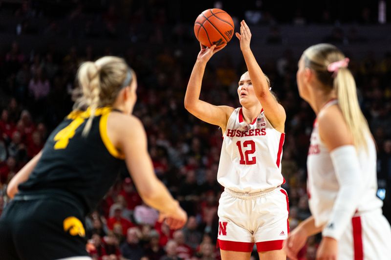 Feb 11, 2024; Lincoln, Nebraska, USA; Nebraska Cornhuskers forward Jessica Petrie (12) shoots a three point shot against the Iowa Hawkeyes during the first quarter at Pinnacle Bank Arena. Mandatory Credit: Dylan Widger-USA TODAY Sports