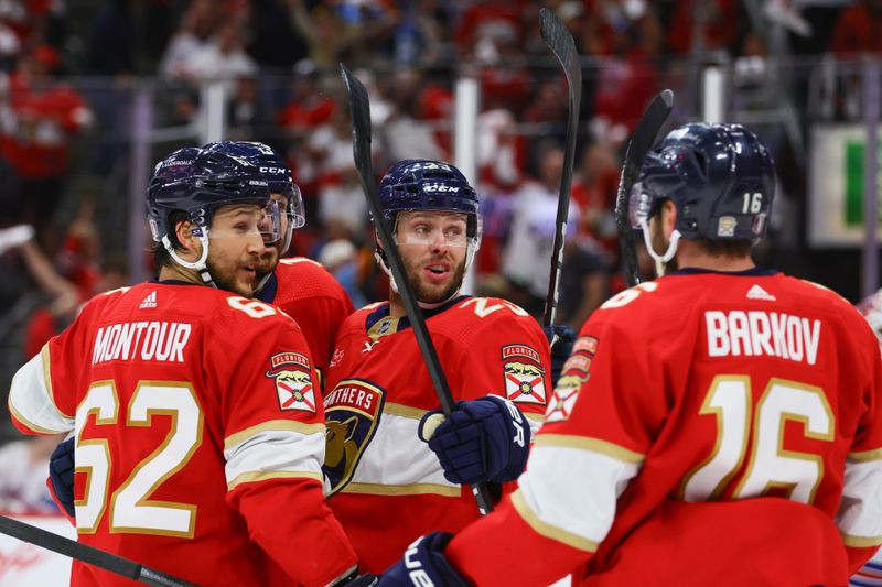 May 26, 2024; Sunrise, Florida, USA; Florida Panthers center Sam Reinhart (13) celebrates with defenseman Brandon Montour (62), center Carter Verhaeghe (23) and center Aleksander Barkov (16) after scoring against the New York Rangers during the first period in game three of the Eastern Conference Final of the 2024 Stanley Cup Playoffs at Amerant Bank Arena. Mandatory Credit: Sam Navarro-USA TODAY Sports